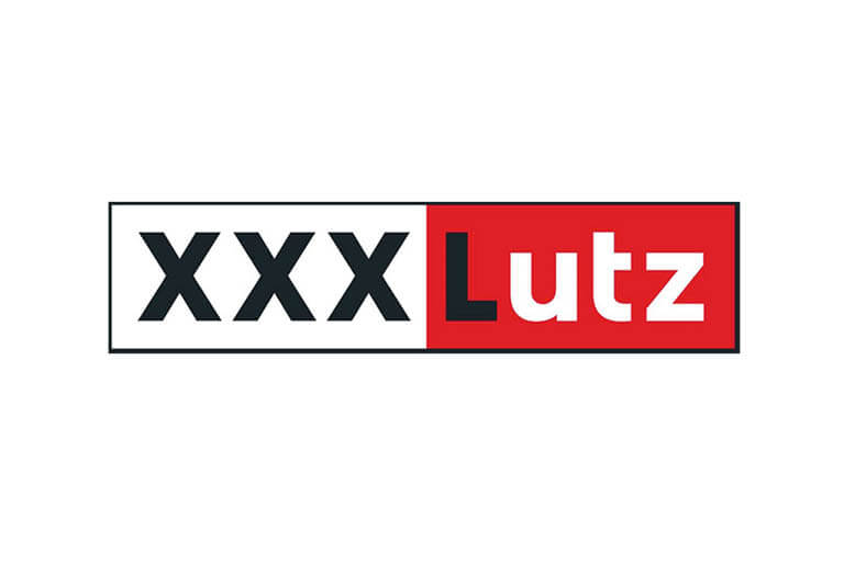 Logo de XXXLutz avec "XXX" en noir sur fond blanc et "Lutz" en blanc sur fond rouge, séparés par une ligne de démarcation verticale, le tout dans un cadre rectangulaire.